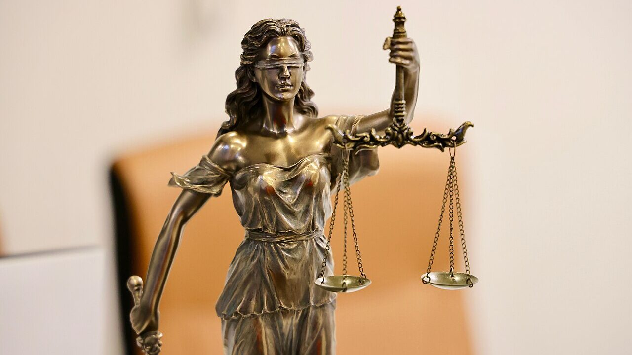 Close up of a Lady Justice statue holding the scales of justice